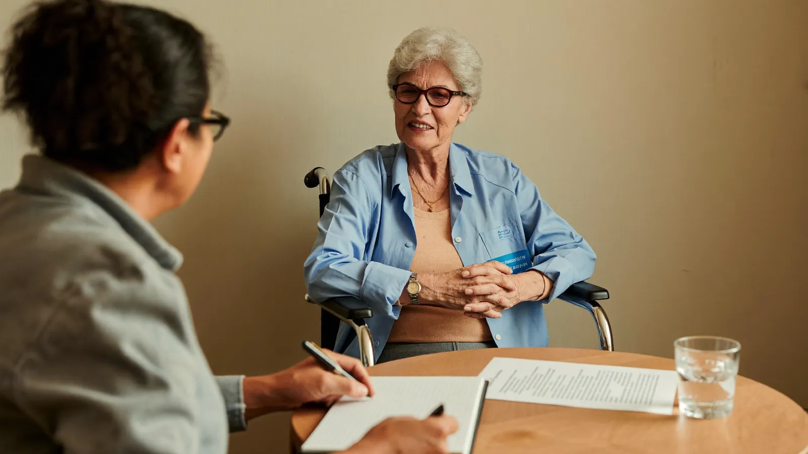 A senior care advisor listening and taking notes during a first family consultation
