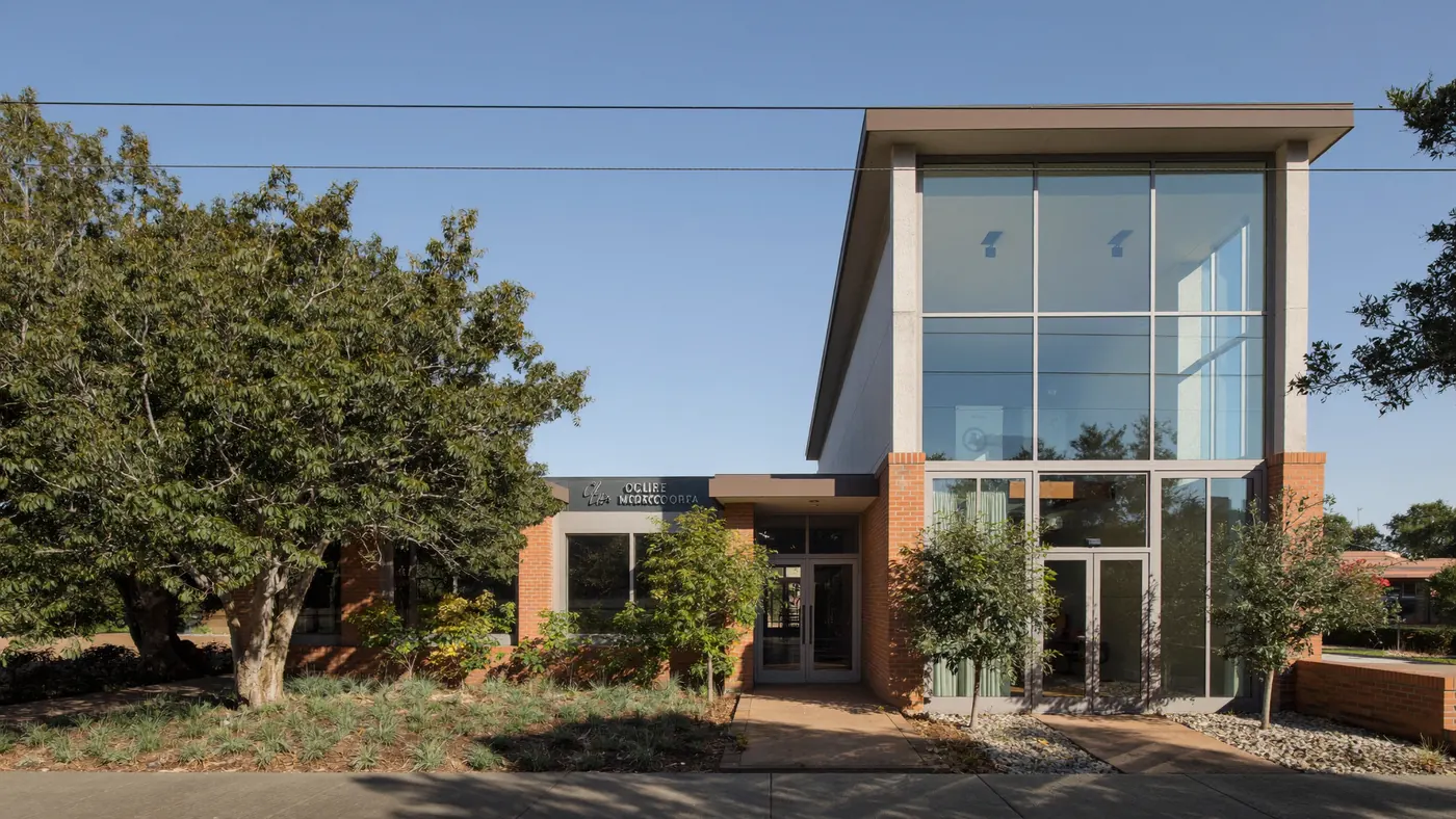 The exterior of a small brick and glass professional office building in Greenwood Village