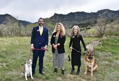 The Above & Beyond team with their dogs in a Colorado field